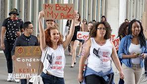 a group of diverse women holding signs that state my body my rules
